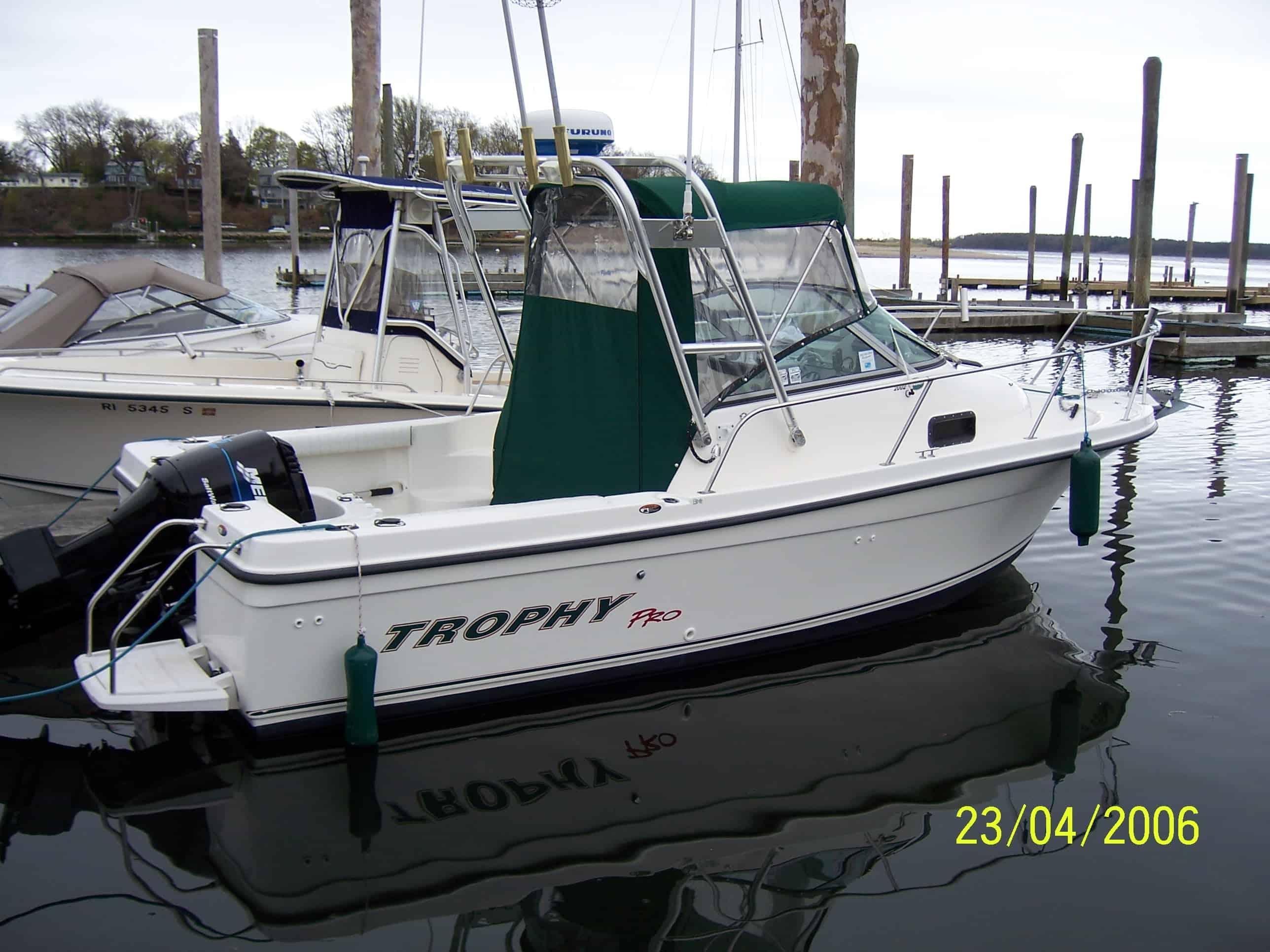 Atlantic Towers arch installed on a Trophy 2002 Pro boat docked at a marina with calm water reflections.