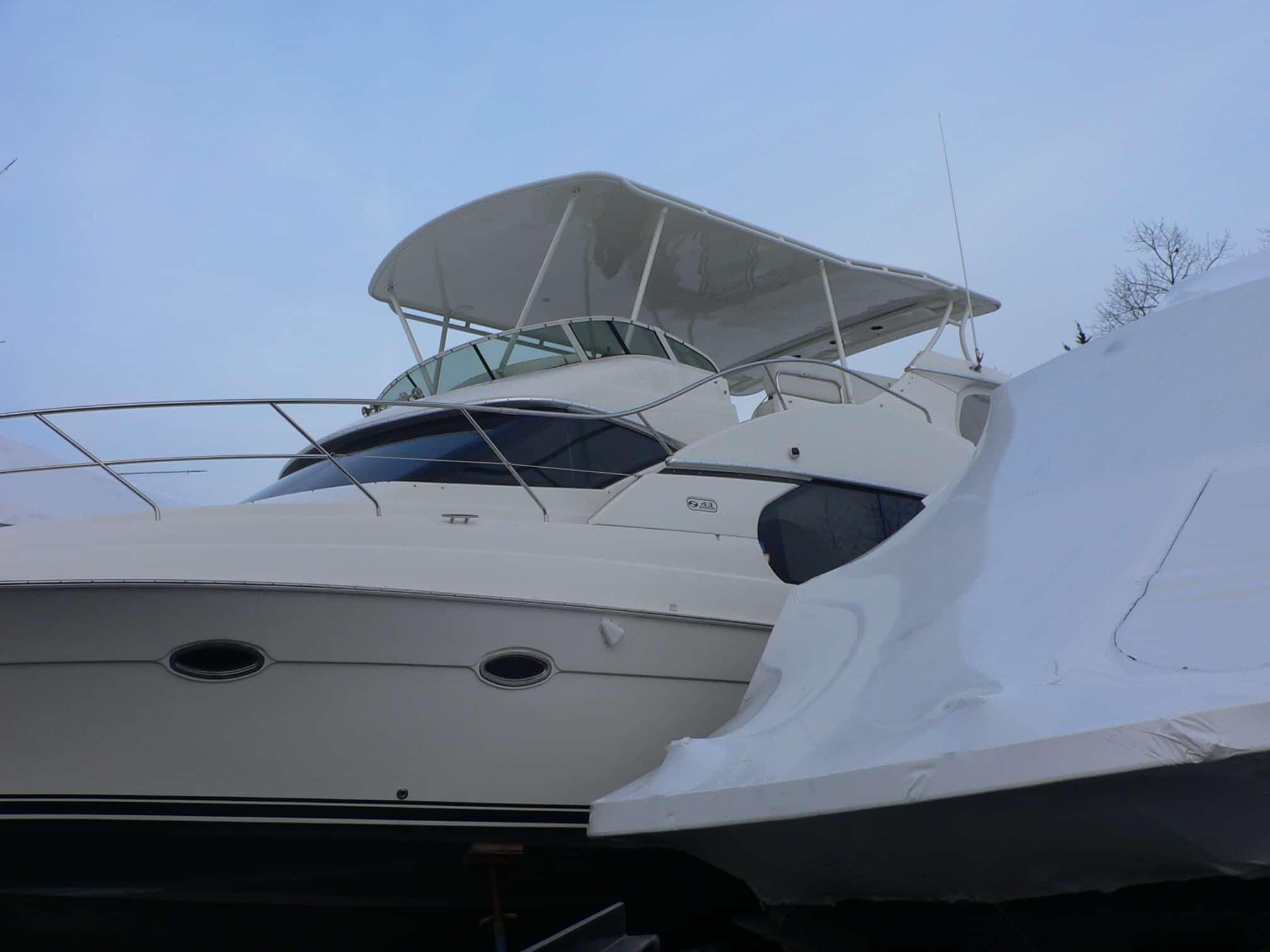 Silverton 43 Motor Yacht with installed Atlantic Towers Top in an outdoor setting next to a covered boat hull