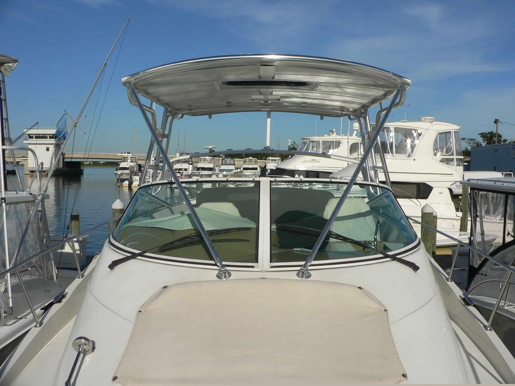 Atlantic Towers Top installed on the front deck of a Carver 350 Mariner boat docked in a marina.