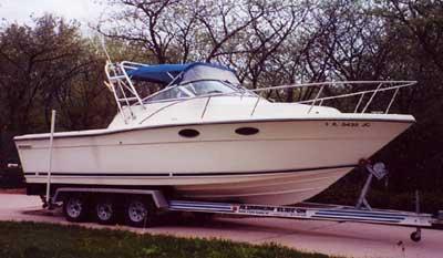 Atlantic Towers Arch installed on a Pursuit 2650 Cuddy boat, showcasing its exterior design and trailer setup.