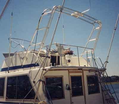 Atlantic Towers Air Tower installed on a Uniflite 38 Convertible boat, showcasing the top deck structure against a clear sky.