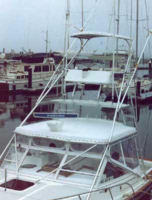 Atlantic Towers Tuna Tower installed on Black Watch 30 Sportfisherman boat docked in marina with other boats.