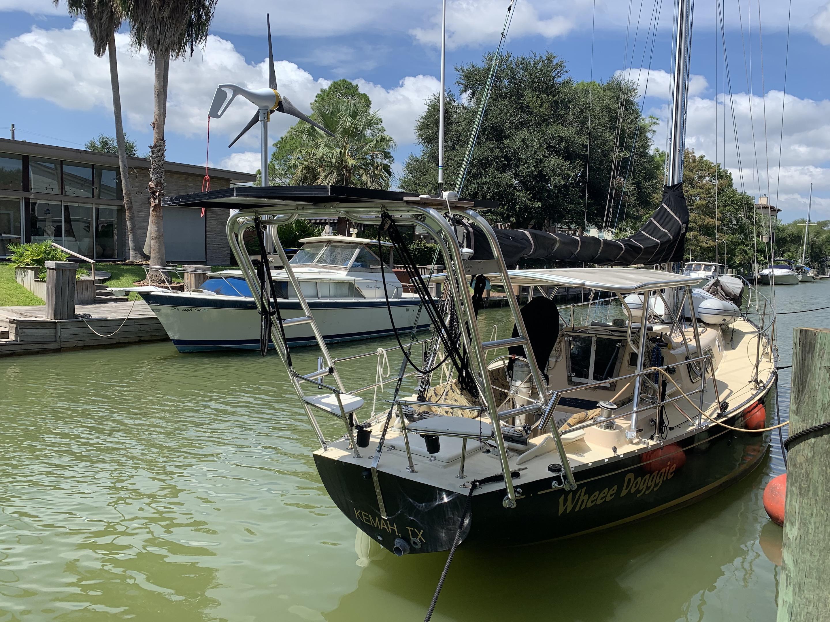 Atlantic Towers Top installed on a boat named 'Whee Doggie' in a marina with lush greenery and other boats.
