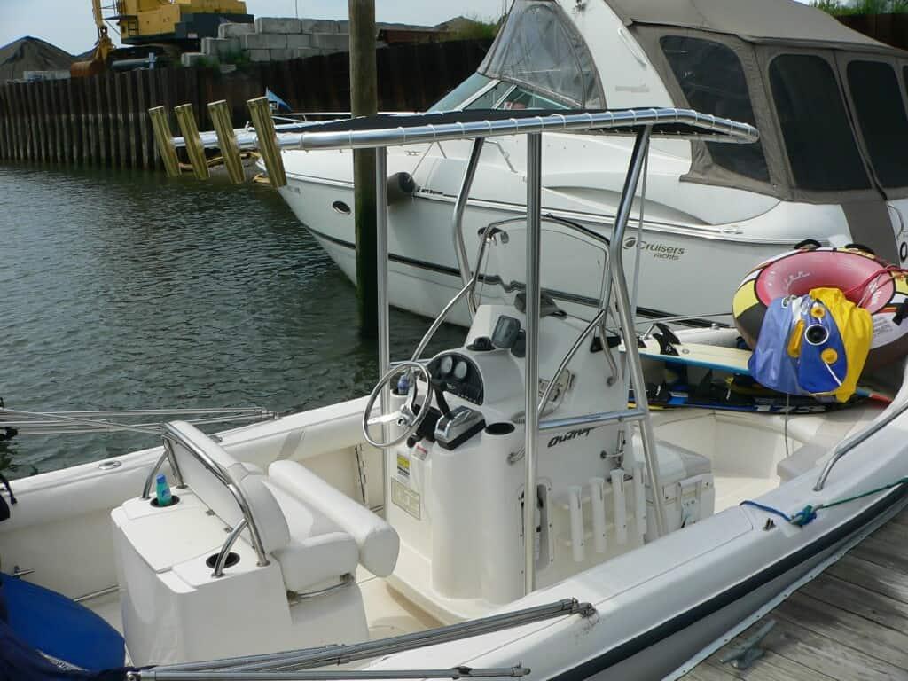 Atlantic Towers T-Top installed on a Boston Whaler 210 Outrage boat at the dock with surrounding water.