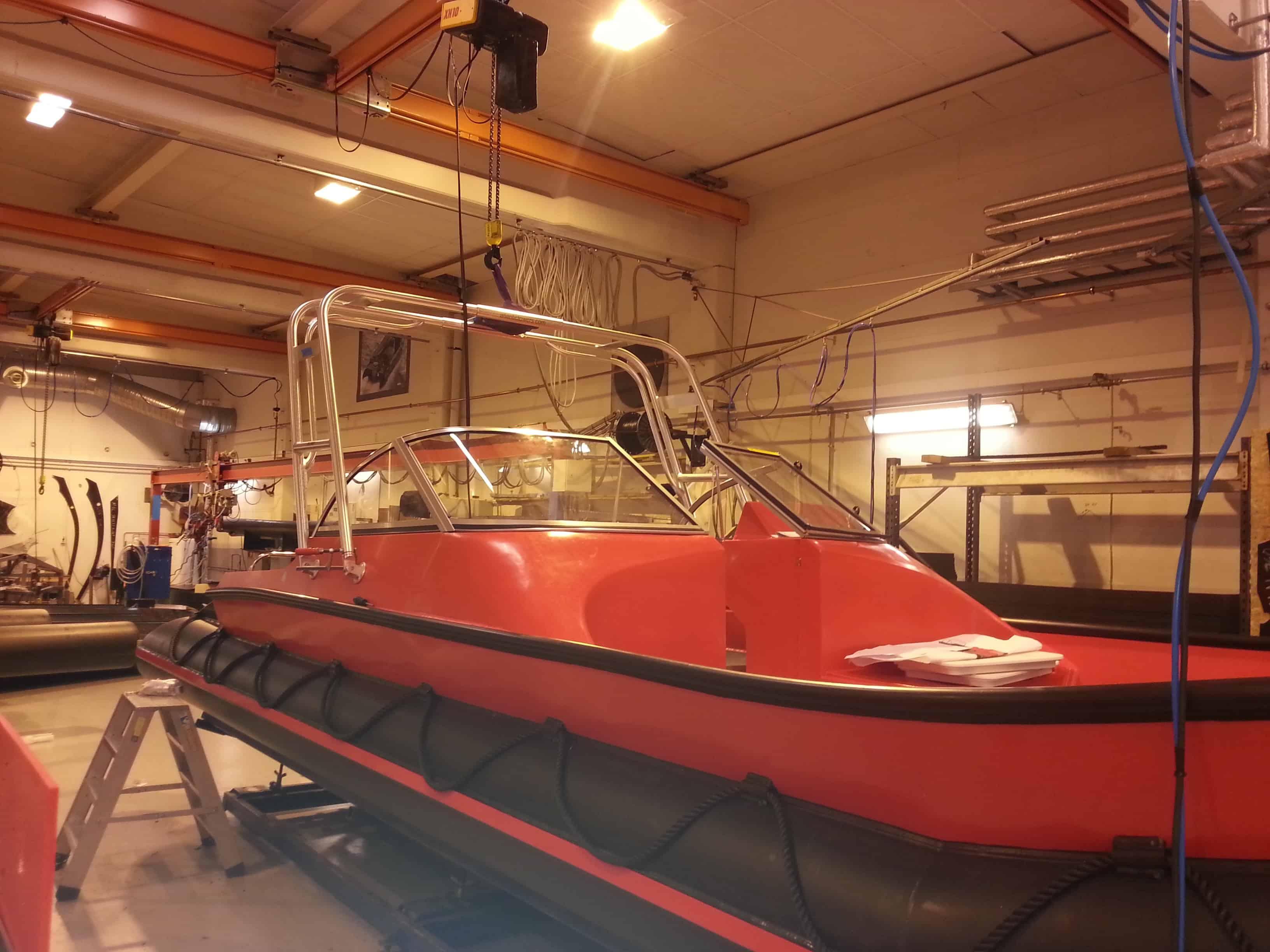 Atlantic Towers Arch installed on a red Polarcirkel boat in a workshop setting.