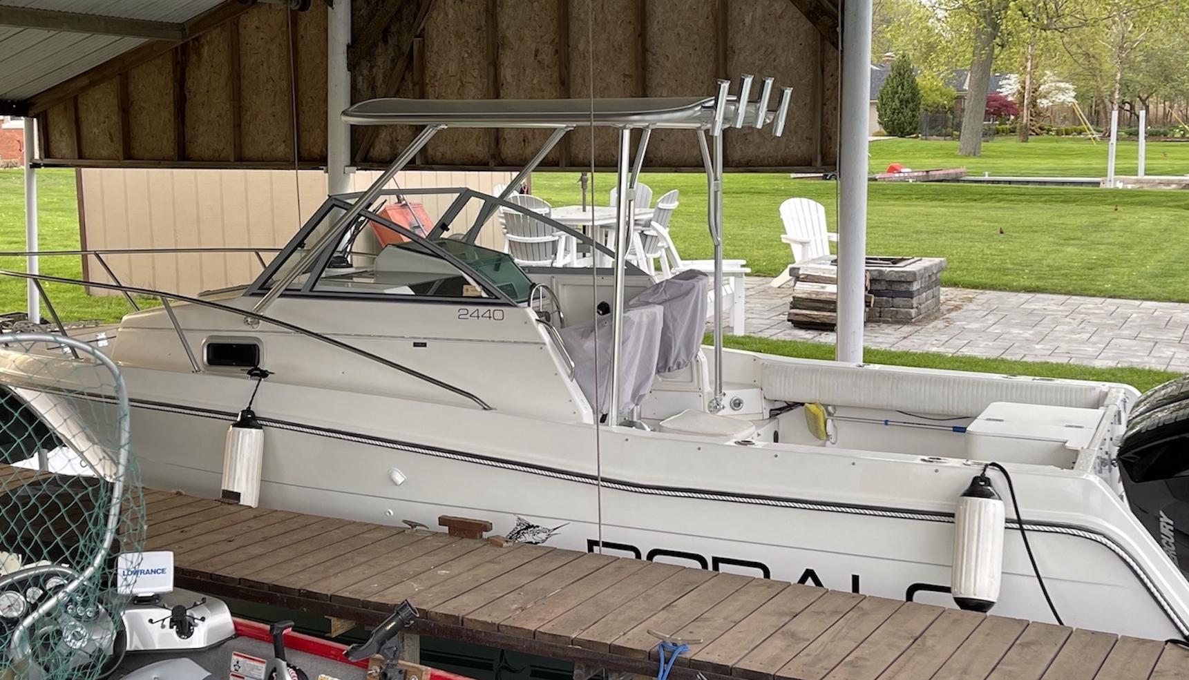 Atlantic Towers Top installed on a Robalo boat, under a covered dock with green lawn in the background.