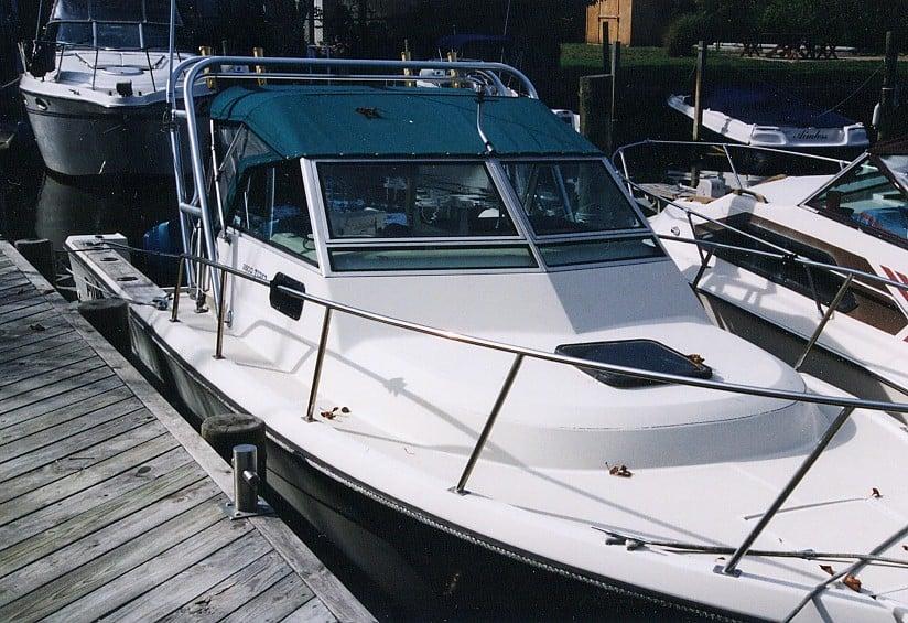 Tiara boat docked with a blue canvas cover and installed Atlantic Towers Arch on the cabin roof.