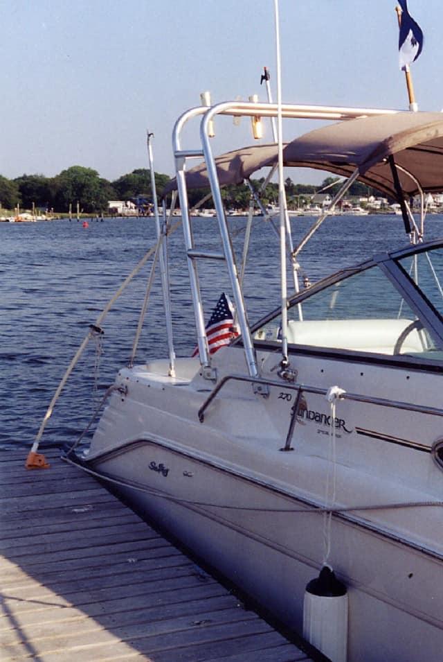 Atlantic Towers arch on a Sea Ray 270 Sundancer, docked by the water with an American flag displayed.