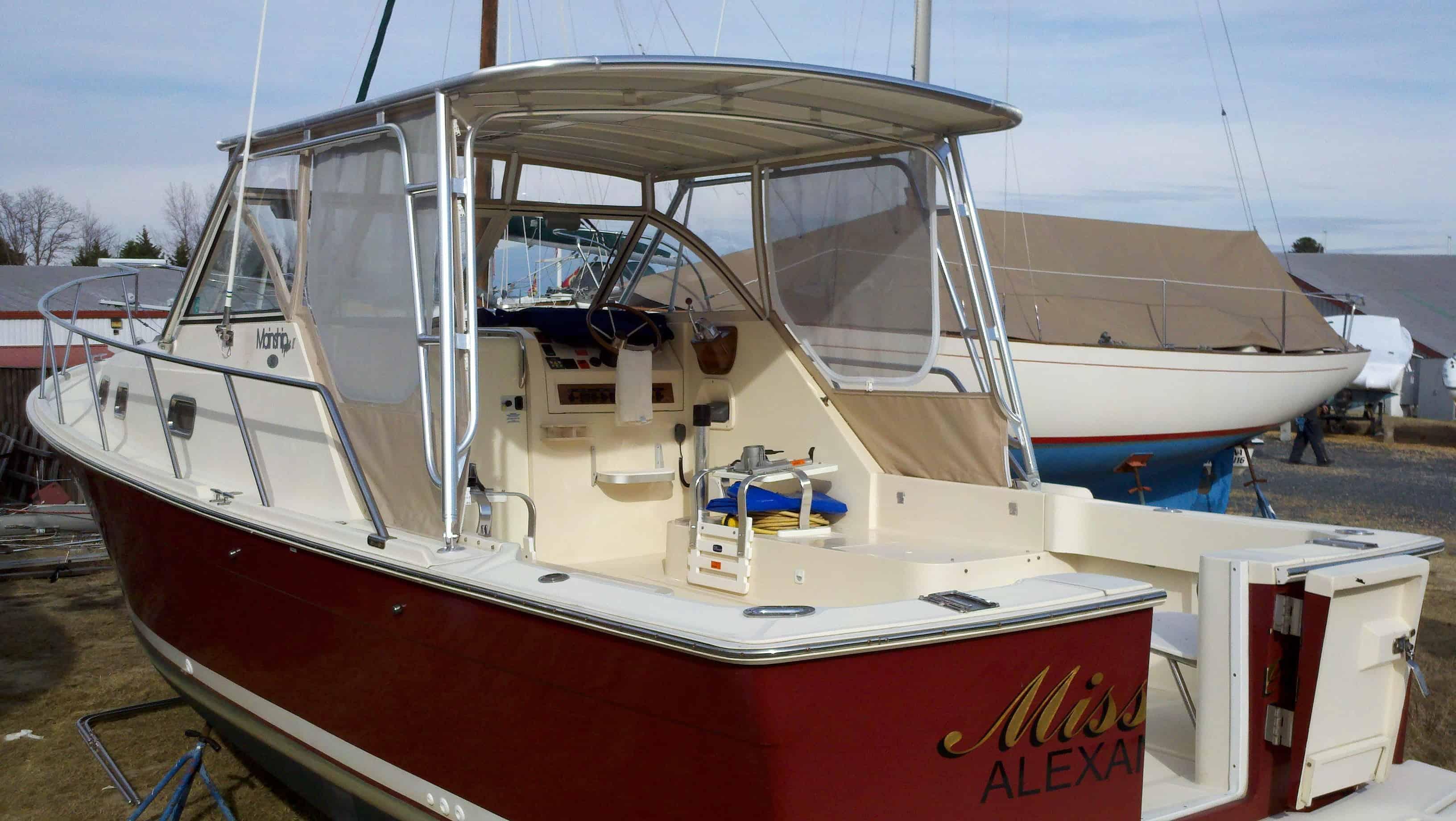 Atlantic Towers Top installed on a boat, showcasing the helm and seating area with a red hull and nearby vessels.