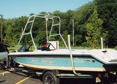 Atlantic Towers Air Tower installed on a Correct Craft Sport Nautique boat, parked with green trees in the background.