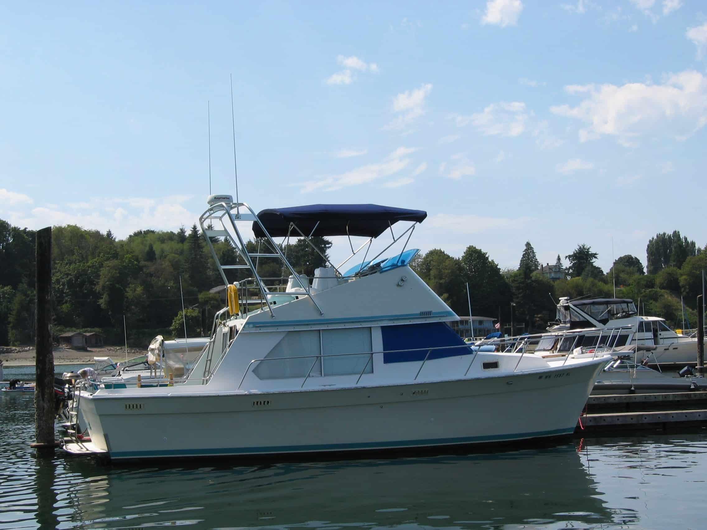 Atlantic Towers Arch on a Tollycraft 34 Sedan boat docked at a marina, surrounded by other boats and greenery.