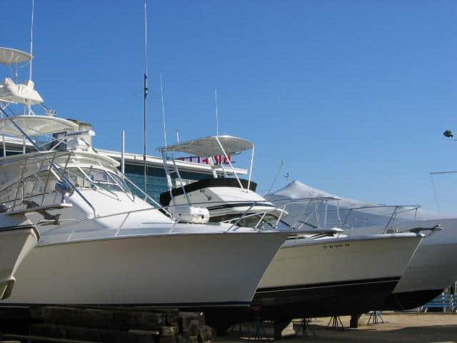 Atlantic Towers Top installed on a Trojan F32 Sedan, showcasing boats in a marina against a clear blue sky.