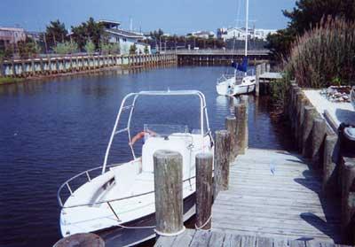 Atlantic Towers Air Tower installed on a Sea Craft 20 Super Fisherman berthed in a calm canal setting.