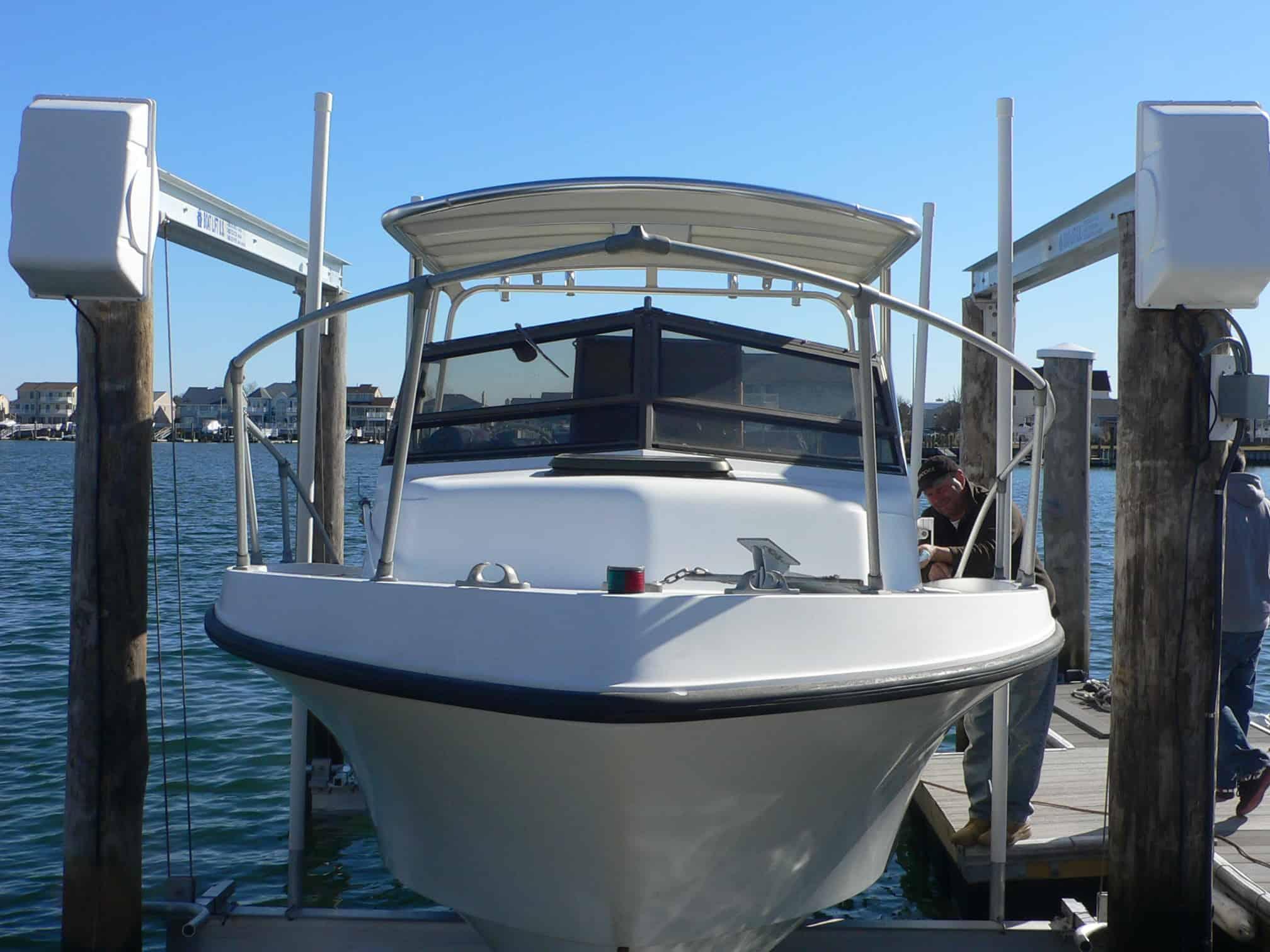 Atlantic Towers Top installed on a Mako 258 Cuddy boat at a marina, with water and buildings in the background.