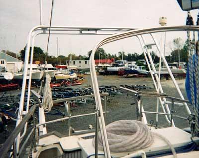 Atlantic Towers Arch installed on a Wauquiez Amphitrite, overlooking a marina with various boats.