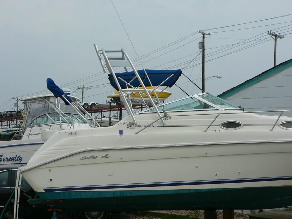 Atlantic Towers Arch installed on a Sea Ray 250 Sundancer boat, parked and covered in a marina setting.