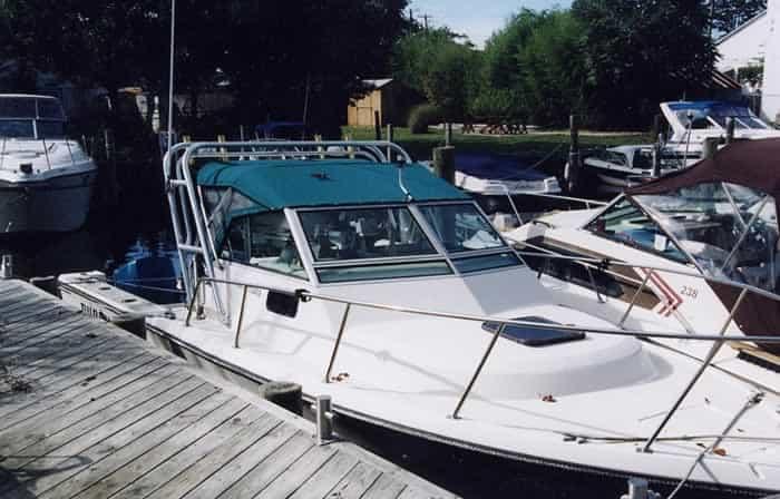 Atlantic Towers Arch installed on a Tiara boat, moored at a dock surrounded by other vessels.
