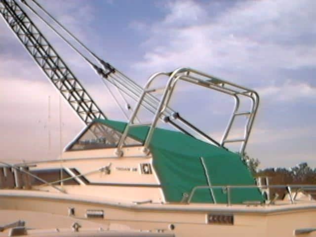 Atlantic Towers Arch installed on Trojan 25 Express boat with green canopy and metal railings in dock setting