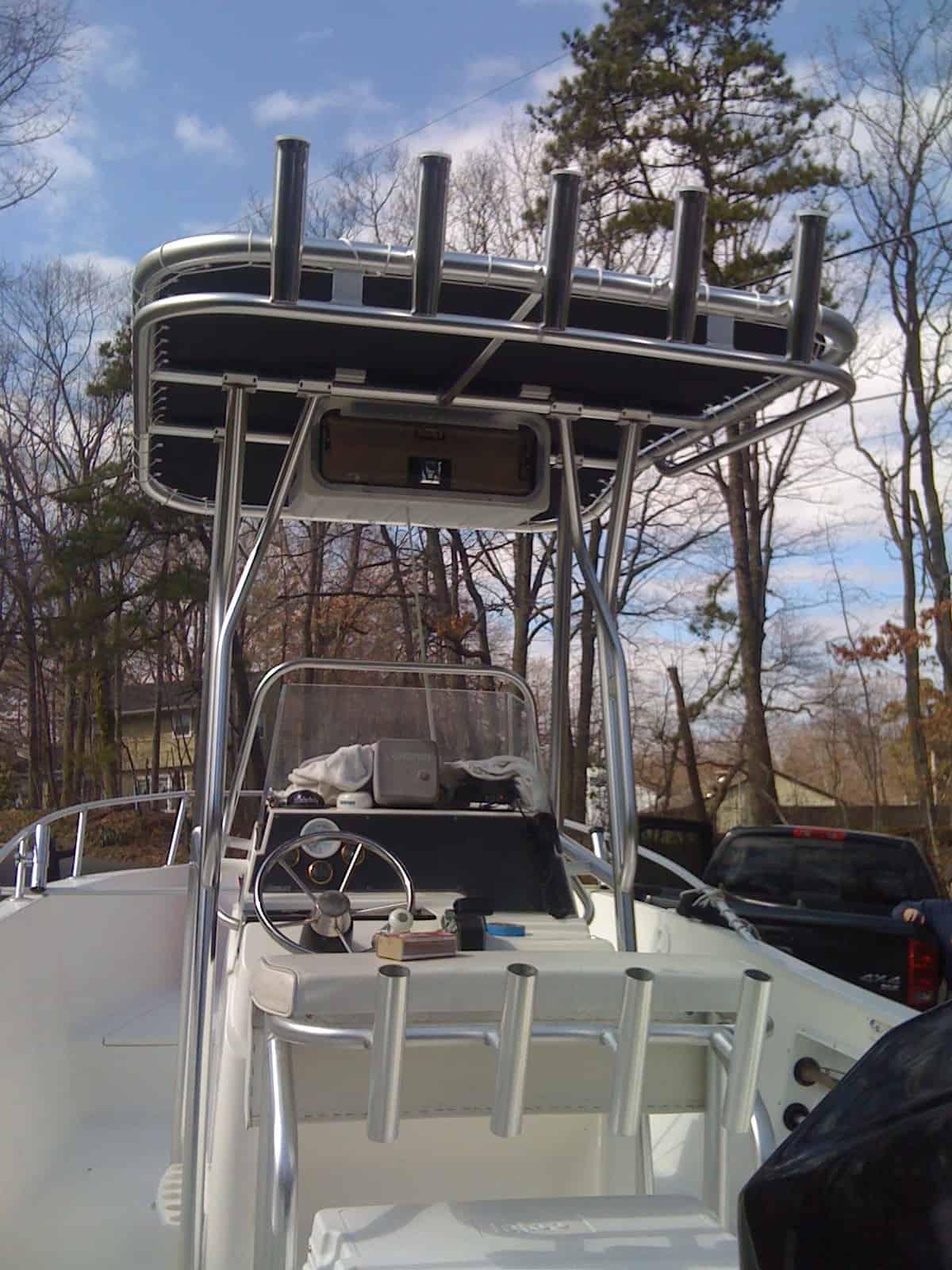 Atlantic Towers T-Top installed on Angler Boats 204 center console boat shown from a side view on water.