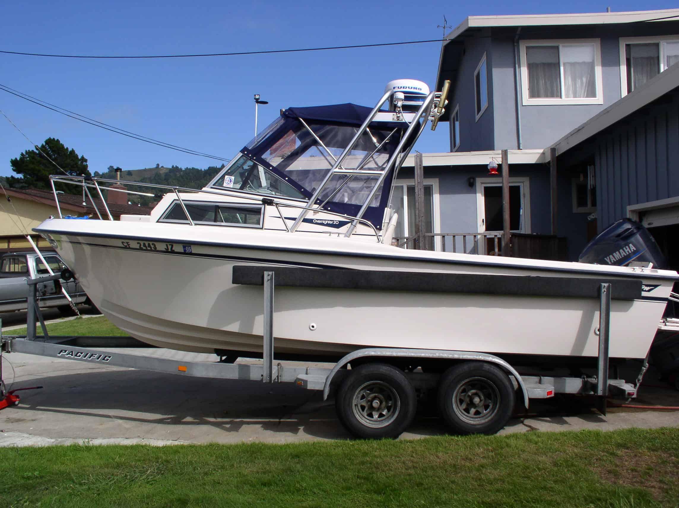 Atlantic Towers Arch installed on a Sea Pro 210 W/A boat, parked on a trailer in a residential area.
