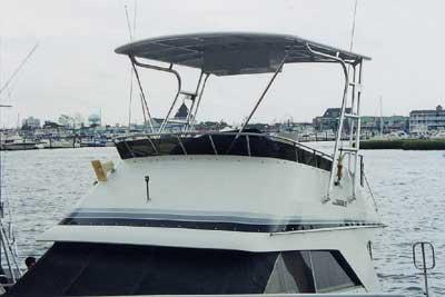 Atlantic Towers Top installed on a Trojan 10.8 Meter Sedan boat, moored near a waterfront.