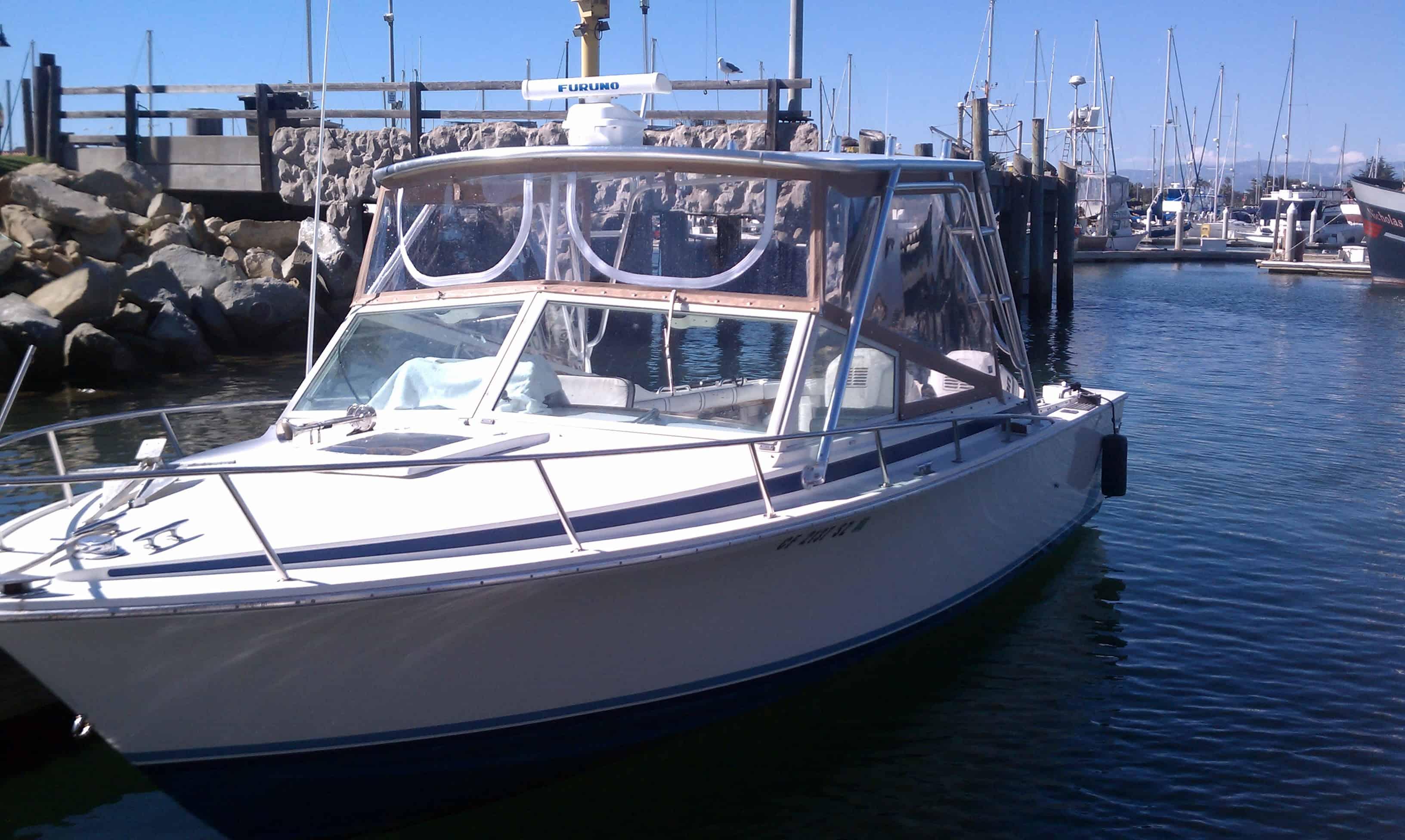 Bertram 26 Sport Convertible boat docked at marina with installed Atlantic Towers Top and radar equipment visible