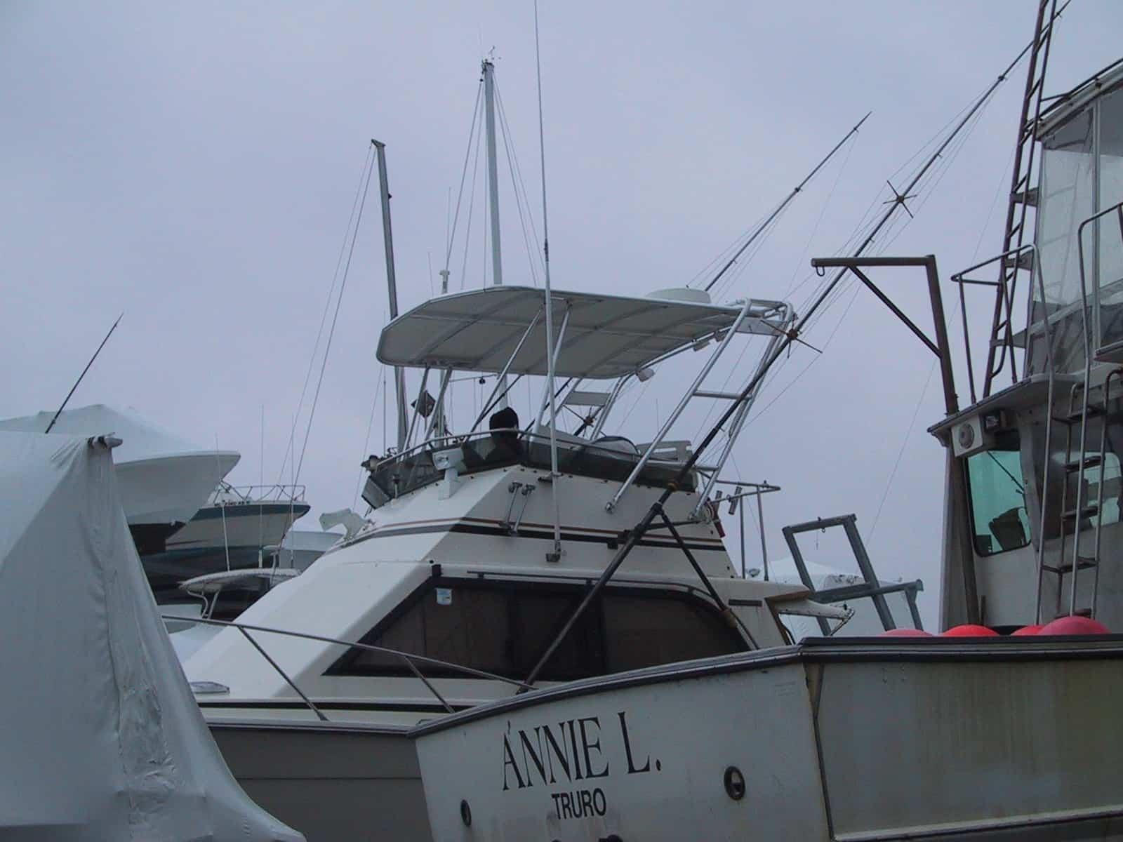 Atlantic Towers Top installed on an Egg Harbor 35 FB boat with fishing equipment docked among other vessels.