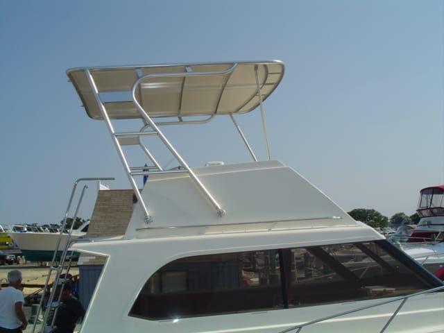 Atlantic Towers Top installed on an Egg Harbor 33 FB boat, showcasing a sleek design against a clear sky.