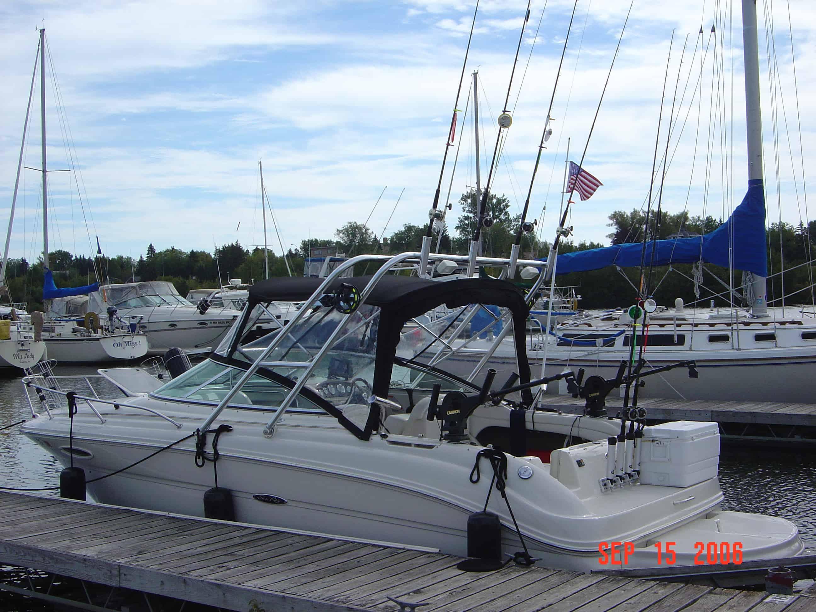 Sea Ray 225 Weekender boat docked with fishing gear and Atlantic Towers arch installed over the cockpit area.