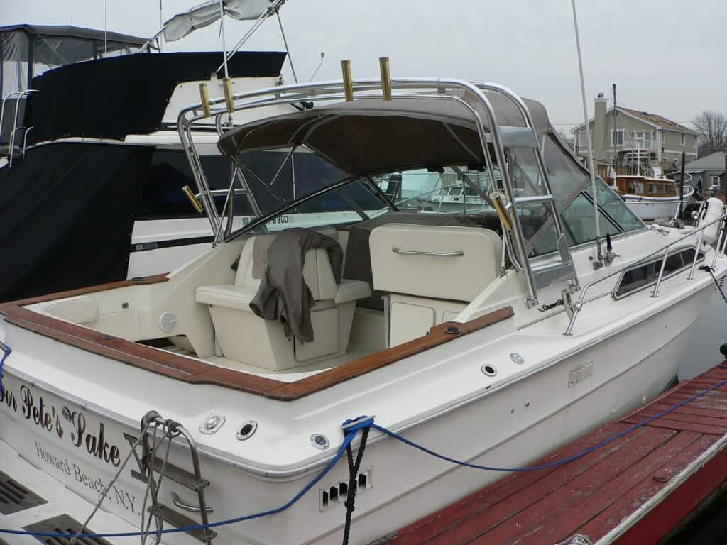 Atlantic Towers arch installed on a Sea Ray 310 SRV Sundancer boat docked at a marina with beige seating and wooden trim