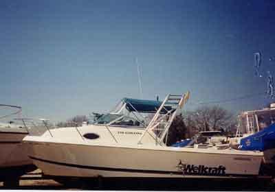Atlantic Towers arch installed on a Wellcraft 210 Coastal walkaround boat docked by the shore.
