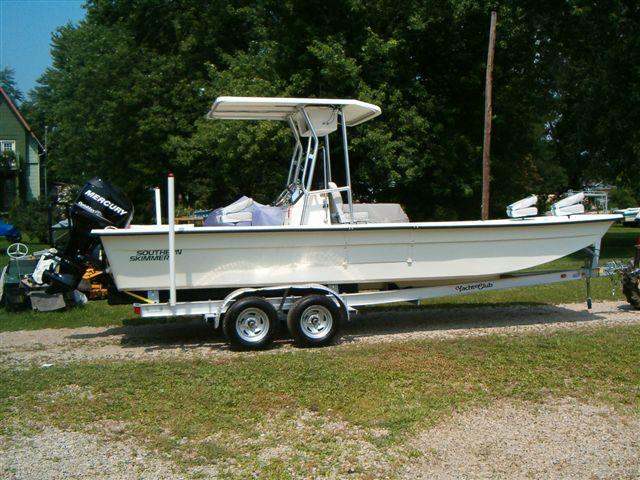 Atlantic Towers T-Top installed on South Skimmer 2480 center console boat shown on calm water with clear sky.