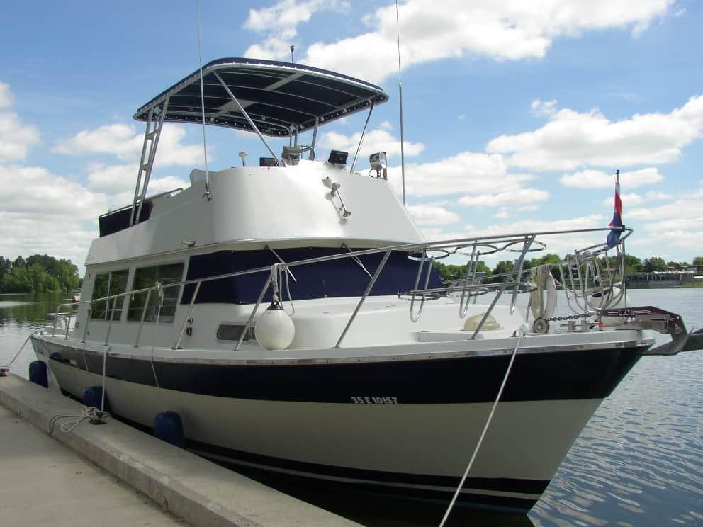 Luhrs 360 Offshore boat docked with installed Atlantic Towers Top providing shade and mounted equipment on the upper deck.