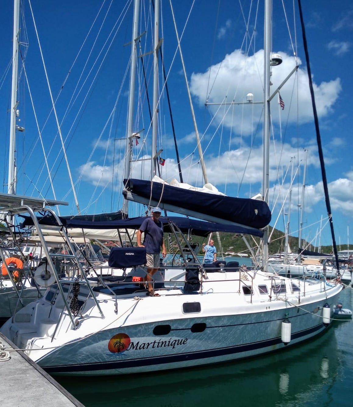 Atlantic Towers Arch installed on a sailboat docked at a marina, with a man standing on deck.