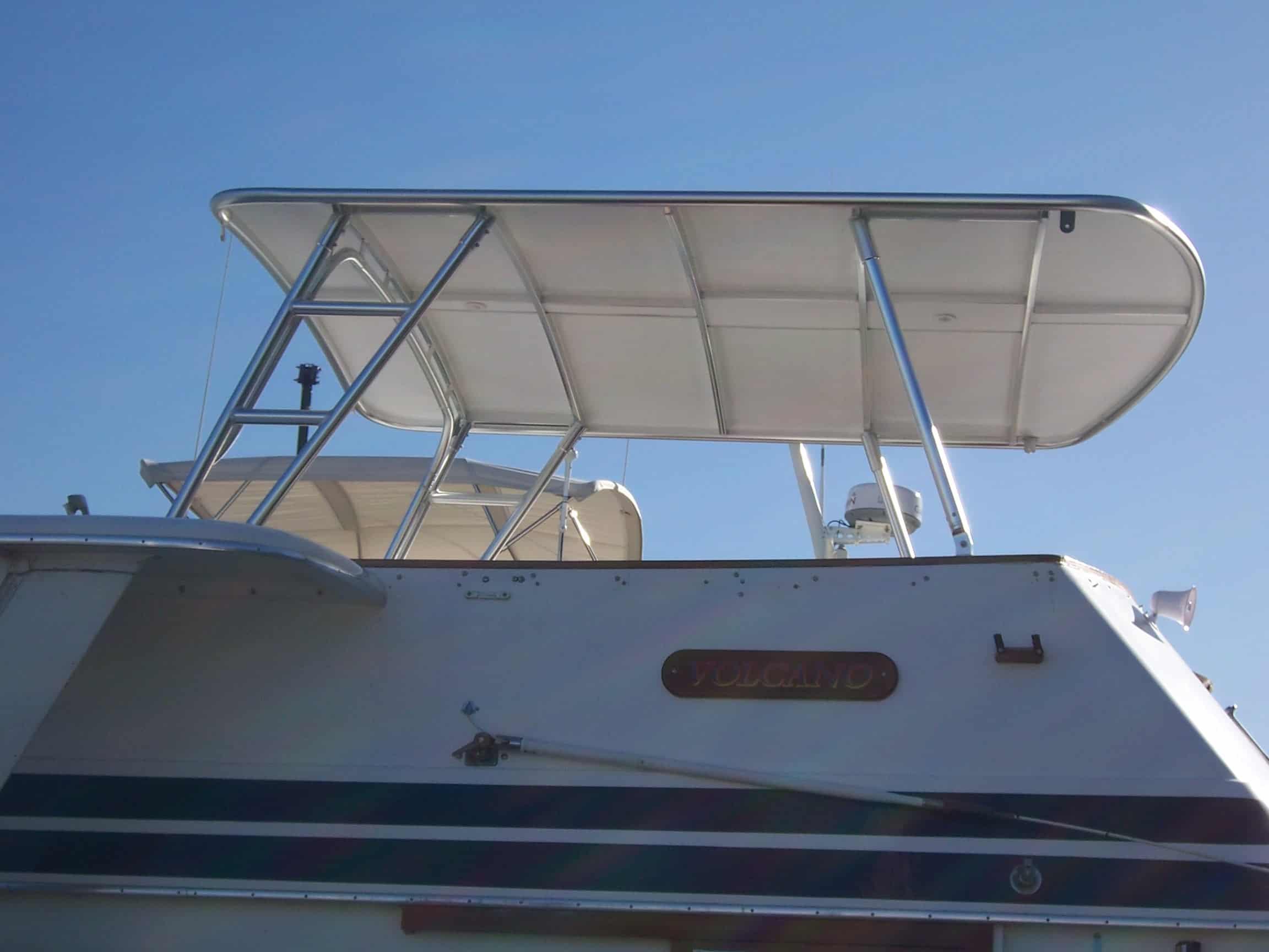 Atlantic Towers Top mounted on a Gulfstar 44 Motor Yacht, showcasing a sleek design under a clear blue sky.
