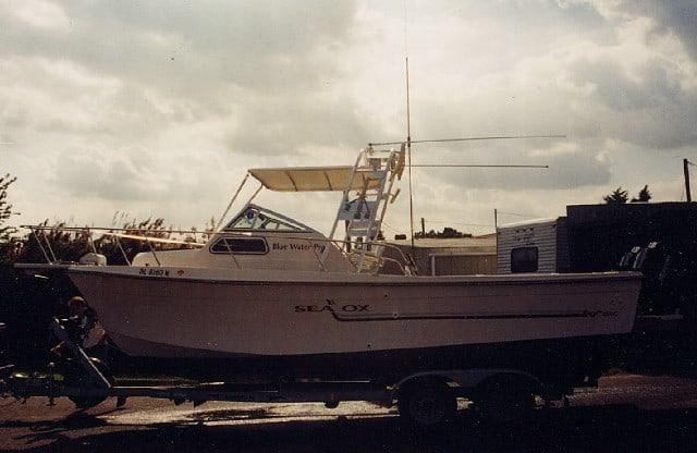 Atlantic Towers Top installed on a Sea Ox Blue Water boat on a trailer with a cloudy sky background.