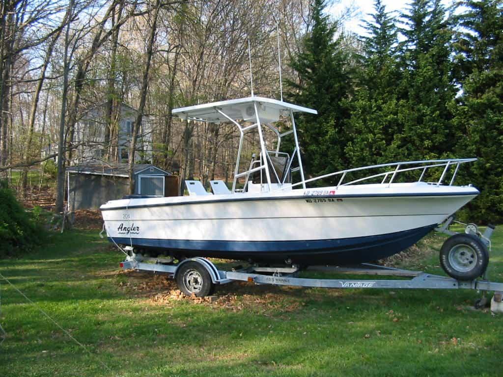 Atlantic Towers T-Top installed on an Angler Boats 204 Console, parked on a trailer in a wooded area.