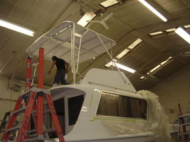 Atlantic Towers Top installed on a Hattaras 41 boat in an indoor workshop with a person working on it.