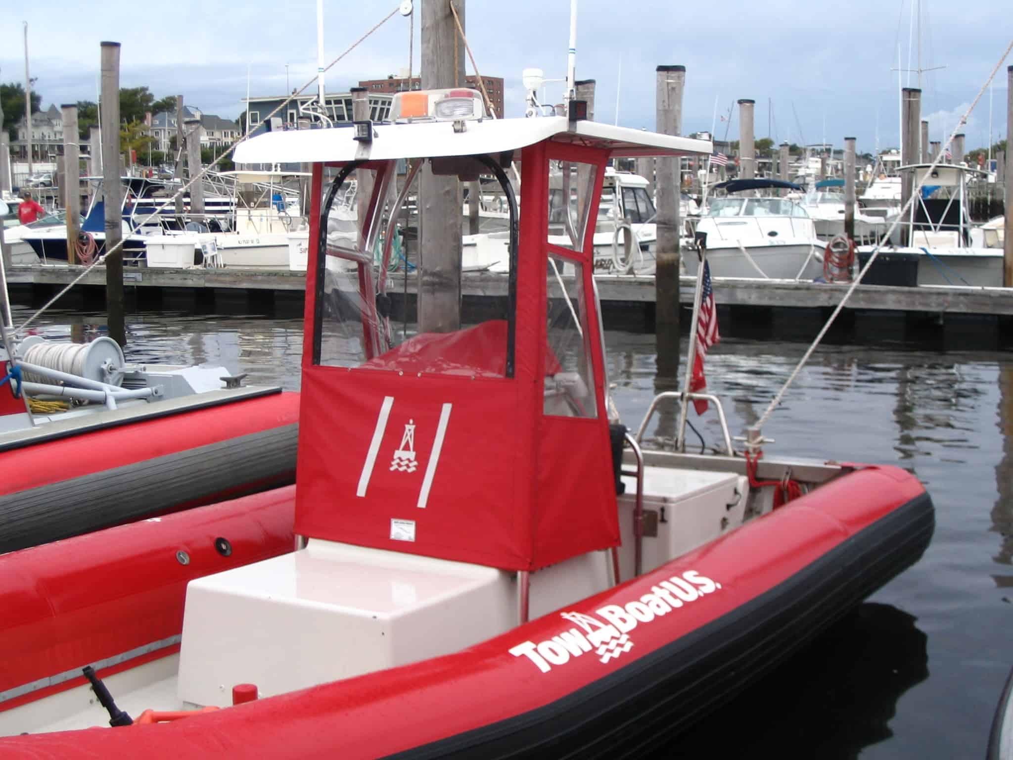 Atlantic Towers T-Top installed on a red Willard Rib boat docked at a marina with other boats in the background.