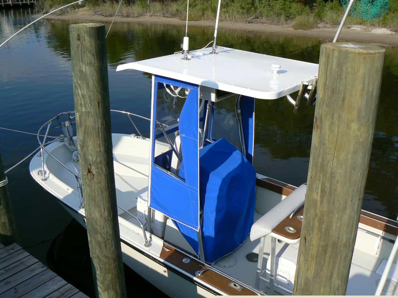 Atlantic Towers T-Top installed on a Boston Whaler 18/19 Outrage boat, docked near wooden pilings.