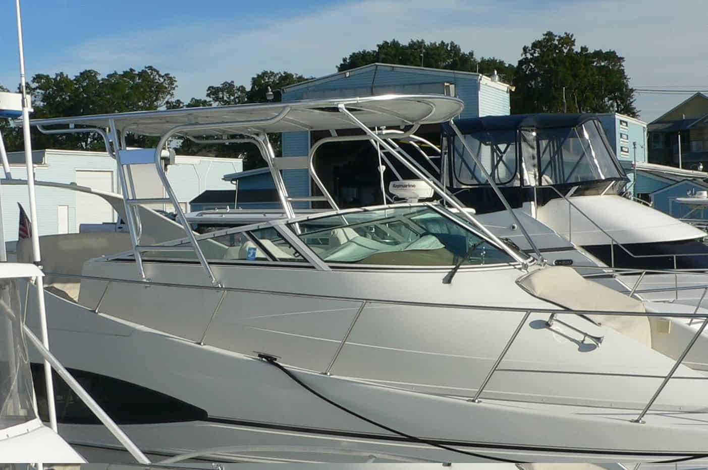 Carver 350 Mariner boat docked with installed Atlantic Towers Top providing shade and support over the cockpit.