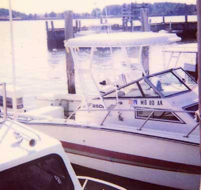 Hydra Sports 2500 WA boat docked with white Atlantic Towers Top installed above the center console at a marina.