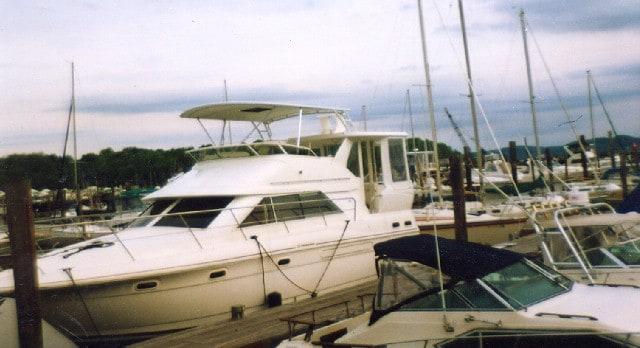 Atlantic Towers Top installed on a Cruisers 3750 Aft Cabin boat at a marina, surrounded by other boats.