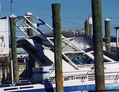 Atlantic Towers Arch installed on a Cruisers Esprit 3160/3260/3170/3270, docked among wooden pilings.