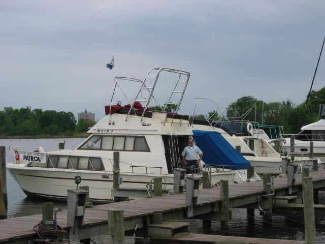 Atlantic Towers Arch installed on a Carver 3396 Voyager docked at a marina, with a man standing nearby.