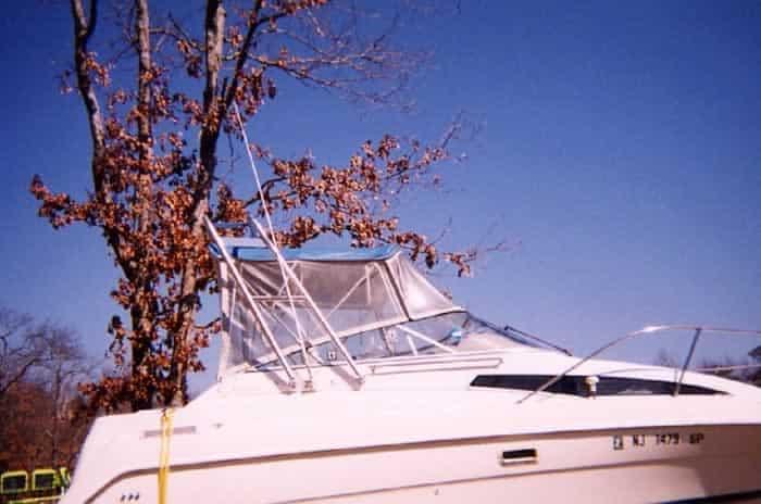 Bayliner 2355 Ciera boat equipped with Atlantic Towers arch and a protective canopy on a clear day
