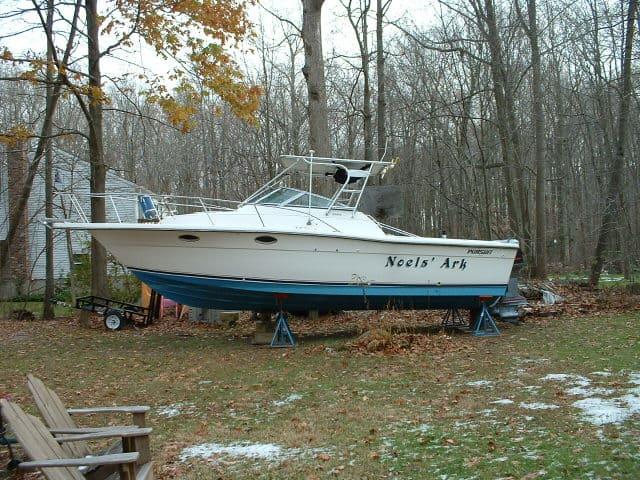 Pursuit 2800 Open boat on stands in a yard during fall with Atlantic Towers Top installed on the cabin roof.