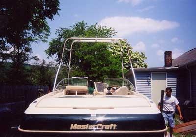 Atlantic Towers Air Tower installed on the rear of a Mastercraft 225/230 boat parked near a house with a man walking nearby.