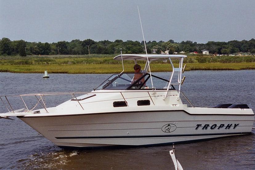 Atlantic Towers Top on a Bayliner 2502 Trophy WA boat cruising on a river with green foliage in the background.