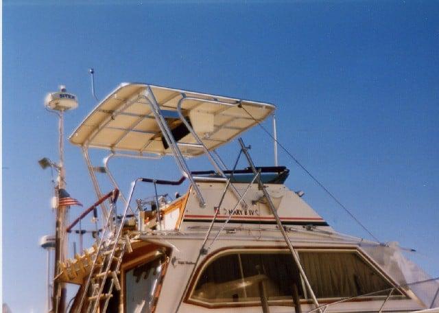 Atlantic Towers Top installed on an Egg Harbor 33 Convertible boat, showcasing its design against a clear blue sky.